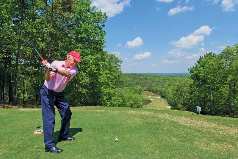 older man playing golf