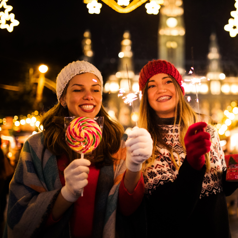 two women enjoying a christmas market